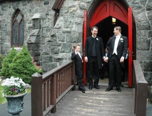 Accompanied by Senan Scott-Hamblen, Father Shane Scott-Hamblen and Steven Lukaj leave St. Mary's Episcopal Church on May 18, 2013, after their wedding. (File photo by Liz Schevtchuk Armstrong)