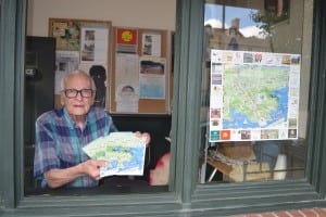 Harry Fadde distributes the Cold Spring Vistors' Map at the Chamber of Commerce information booth on Main Street. (Photo by Michael Turton)