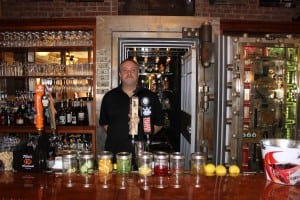 The Vault's manager, John Lombardi, in front of its namesake, the old bank vault (photo by A. Rooney)
