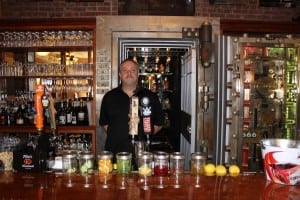 The Vault's manager, John Lombardi, in front of its namesake, the old bank vault (photo by A. Rooney) 