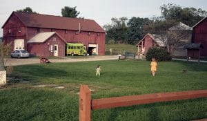 Children playing in a field near Common Ground Farm's barn. (Photo by Dana Devine-O'Malley)