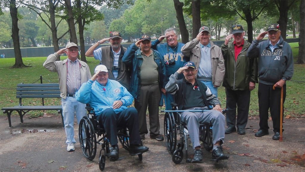 A nine-veteran Cold Spring salute. "The Wall," the Vietnam Veterans War Memorial is in the background. (Photo by Greg Gunder)