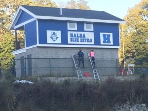 Putting the finishing touches on Haldane's new concession stand and press box