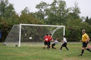 Trajan McCarthy scores one of his two goals on Oct. 2 for the Philipstown Soccer Club's U11 Strikers (Photo by Patrice Delabie)