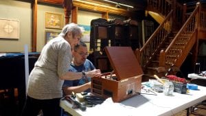 Antony Tseng, one of the organizers of the Beacon Repair Cafe, works on a record player at the first Cafe in May. (Photo by Samantha Tseng)