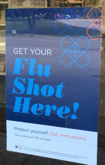 A sign in the window at Drugworld in Cold Spring