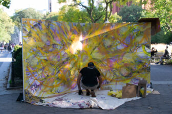 Loray spray painting a layer of "The Art of Dreaming"