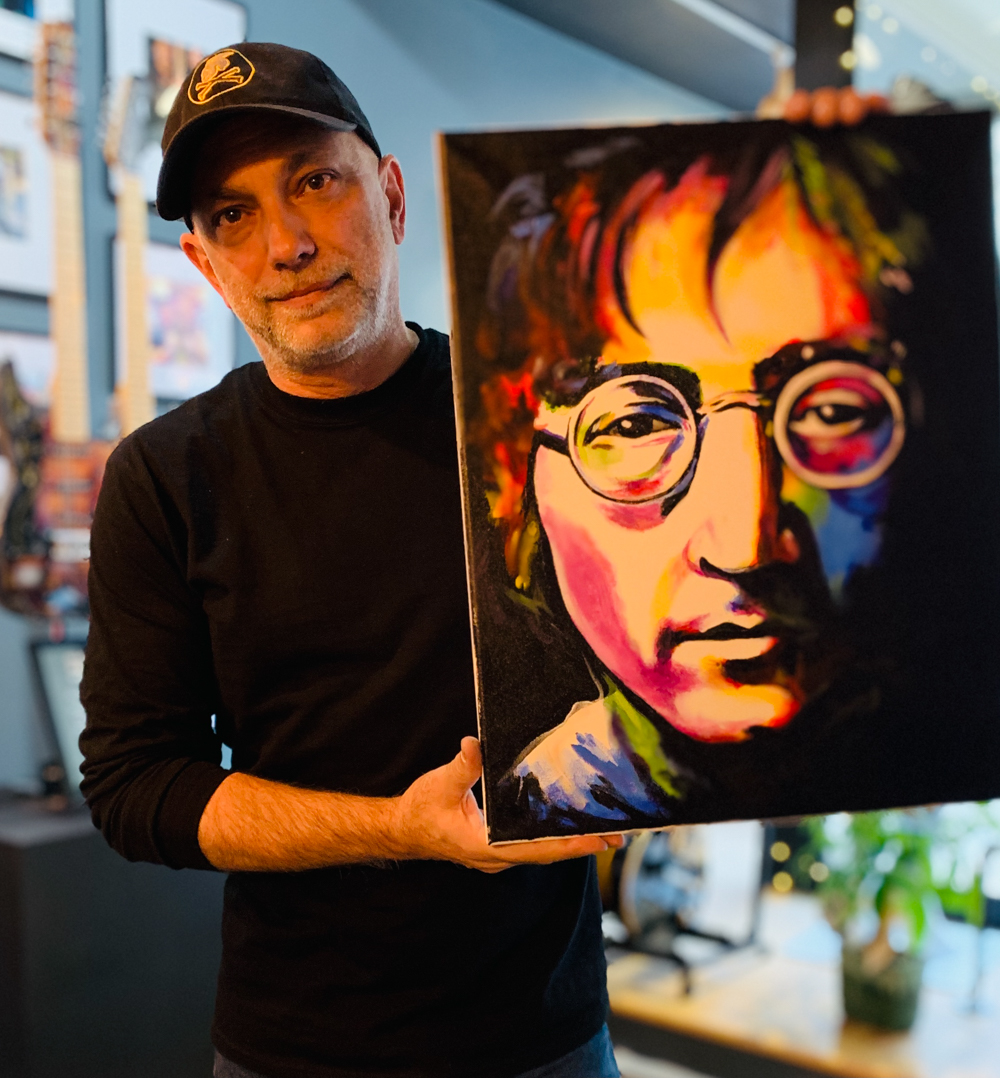 Ron Williams with his portrait of John Lennon