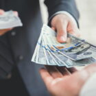 Man handing cash