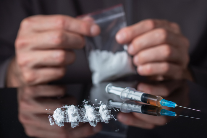 Recreational Drugs on Glass Table - Substance Abuse Concept.