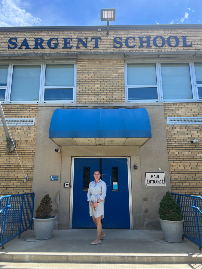 Catie Biordi stands outside Sargent Elementary in Beacon, where she will take over as principal on Aug. 1.