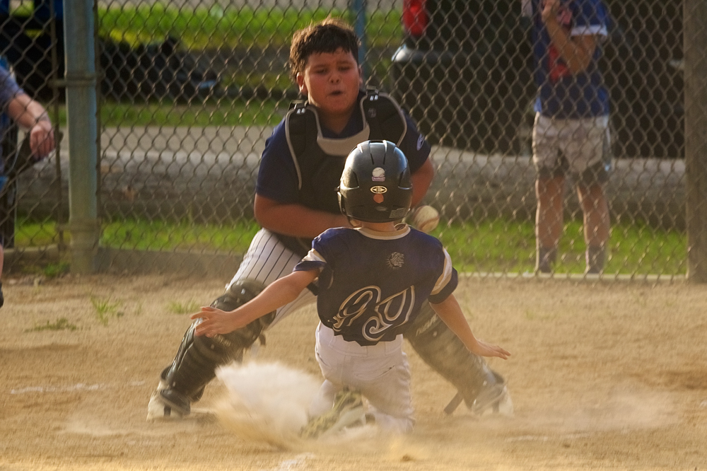 Beacon’s Max Digneo (99) slides in safe at home after the throw hit him in the back Monday at Memorial Park. Photos by S. Pearlman