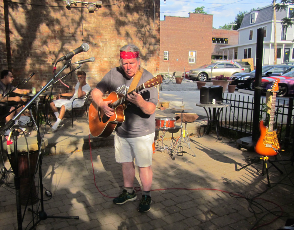 Thom Joyce performs at the Bank Square Coffeehouse, where he hosts an open mic on Wednesdays.