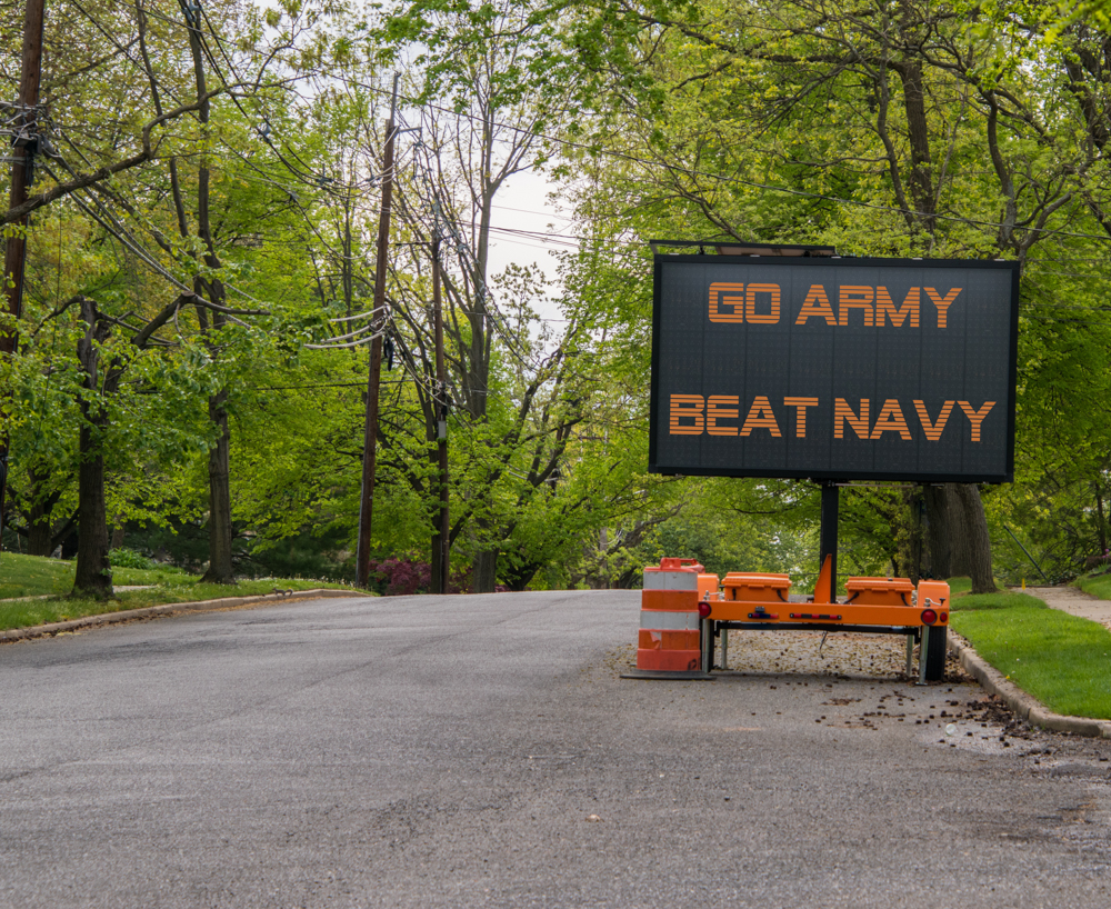 Electronic road sign on a suburban street that says Go Army Beat Navy