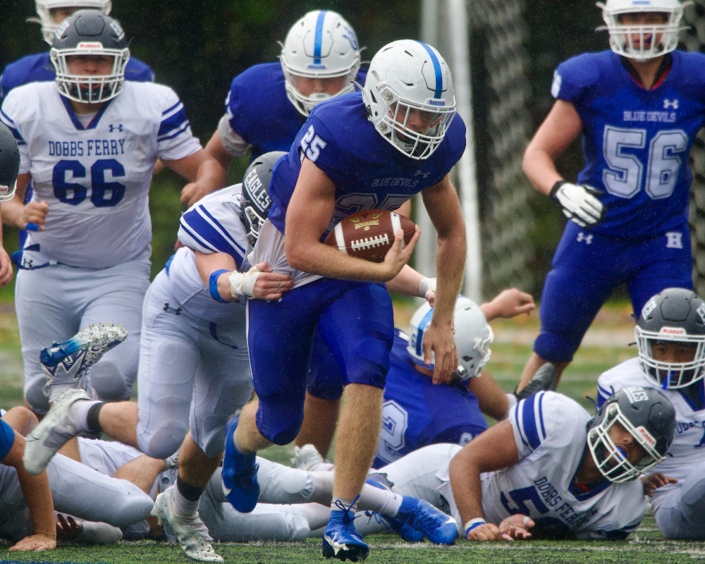 Evan Giachinta drags a defender behind him during a run against Dobbs Ferry. Photo by Skip Pearlman