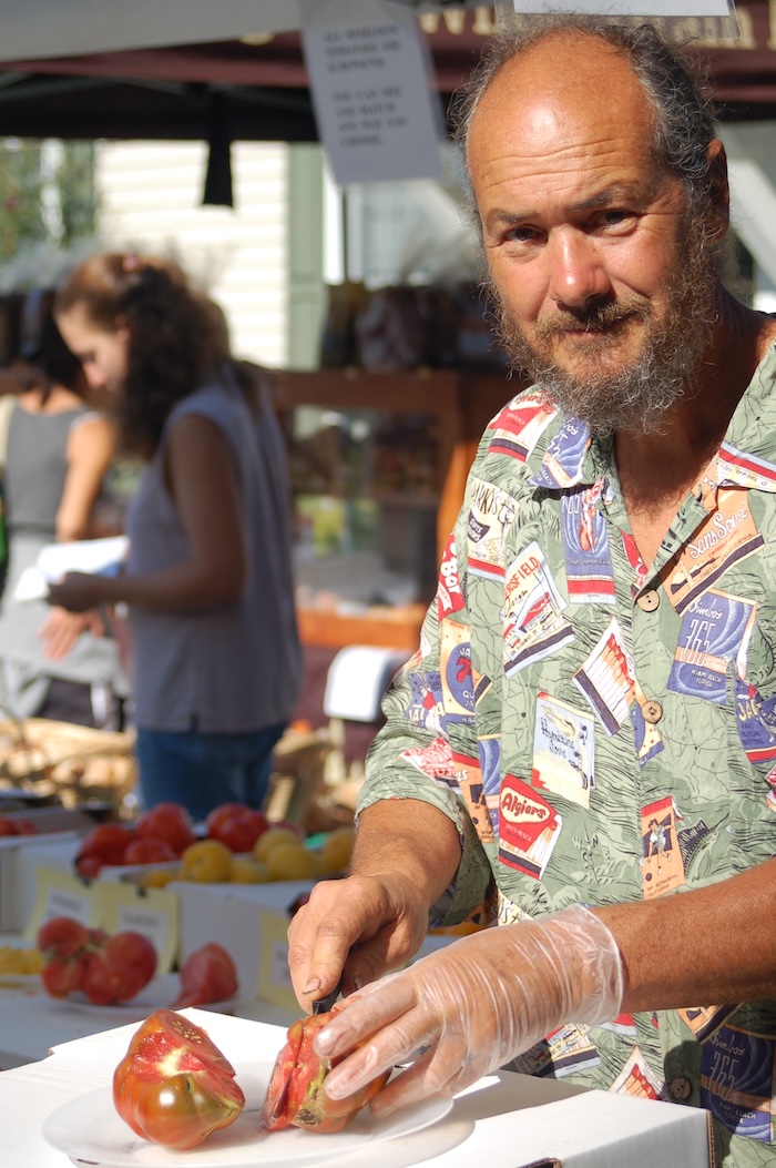 Jay Armour slices samples of heirloom tomatoes at the Cold Spring Farmers' Market