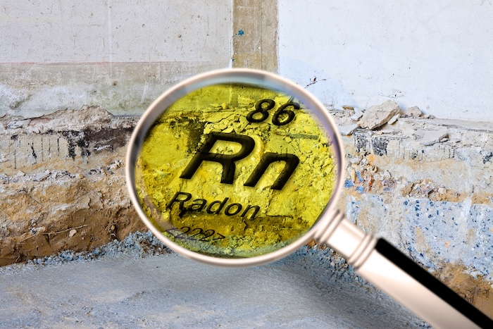 Preparatory stage for the construction of a ventilated crawl space in an old brick building - Searching gas radon concept image seen through a magnifying glass.