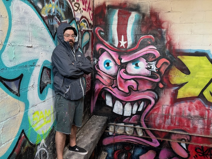 Skatchface with his painting, "Uncle Scram"