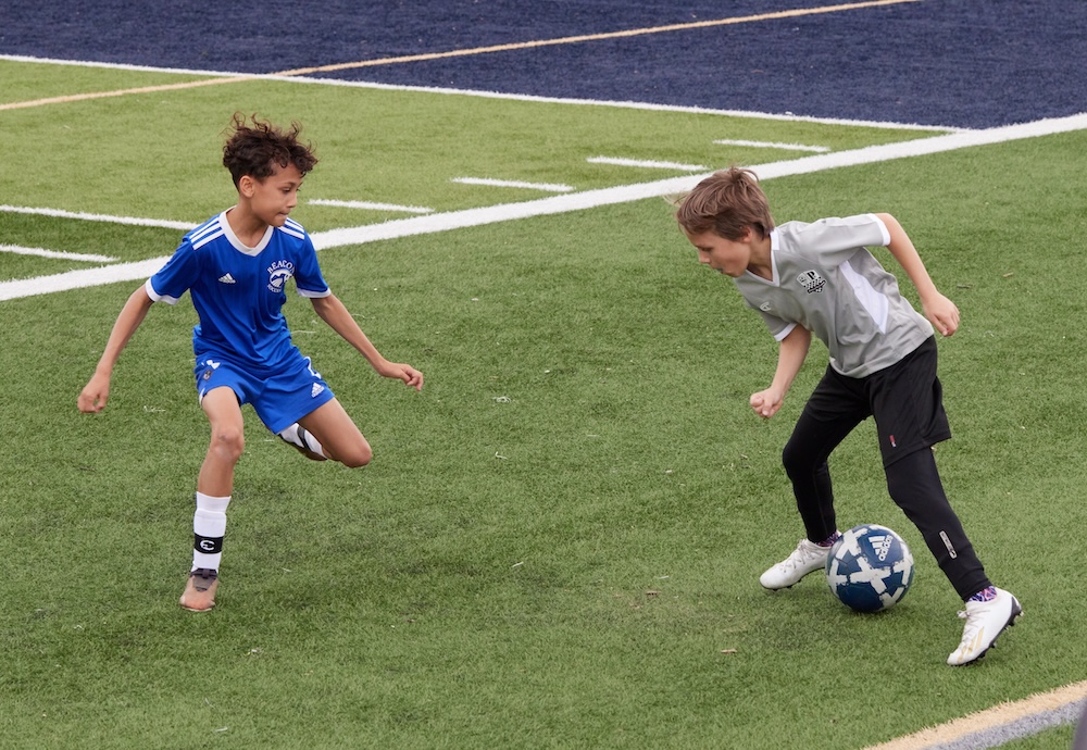 Miles Lucca (right) faces off against a Beacon Wolves defender in a game on April 20.