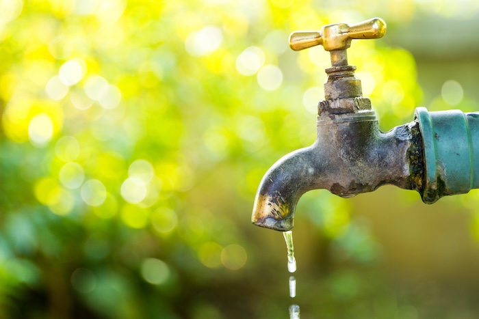 Brass water tap in nature background water faucet