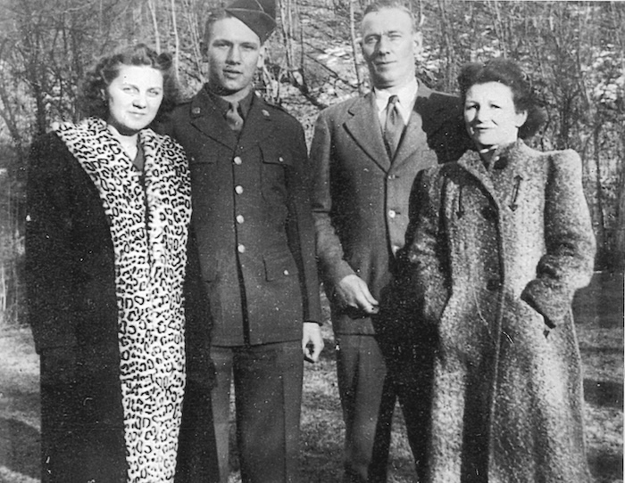 Dot and Buster (left) pose for a family photo in March 1944 while Buster was home on leave before departing for Europe. His parents, Albert and Mary Johnson, are at right.