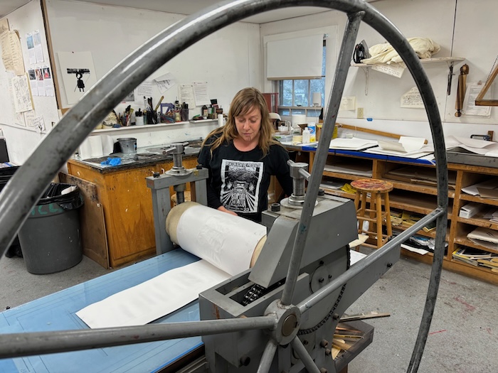 Lauren Adelman, a founder of Roll Out Beacon, prepares the press at the Garrison Art Center. Photos by M. Ferris