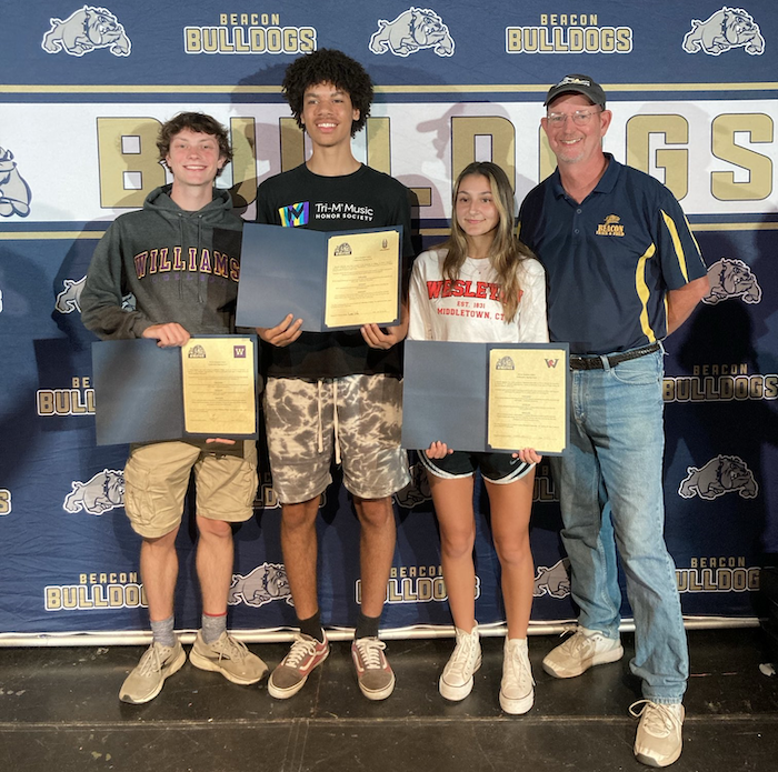 Three Beacon High School track-and-field athletes will compete in college next year: Henry Reinke for Williams College in Massachusetts, Damani DeLoatch for the University at Albany and Isabella Migliore for Wesleyan College in Connecticut. They are shown with Coach Jim Henry.