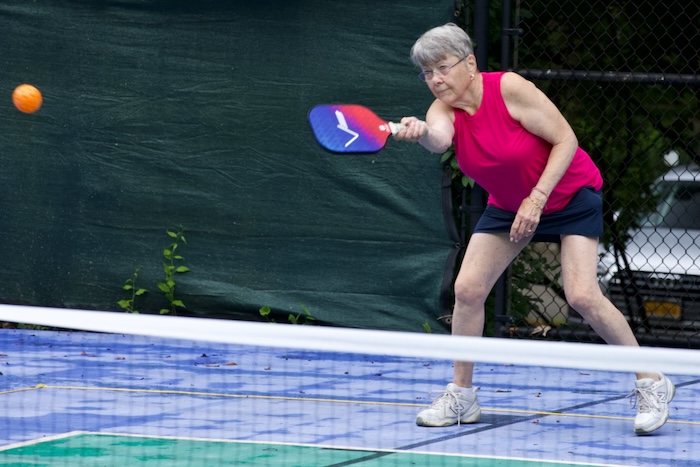 Anne Gonsalves concentrates as she returns a shot. Photos by Ross Corsair
