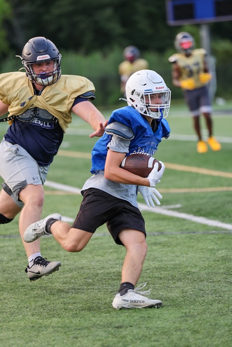 Brody Corless of Haldane eludes the grasp of a Beacon defender.