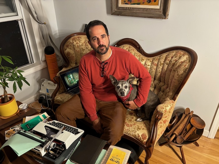 Justin Possenti at home with his dog, Olive Photo by M. Ferris