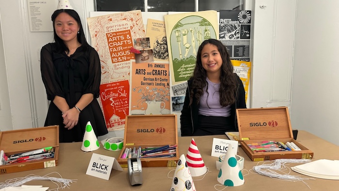 Fiona Dong, 15, and Audrey Kim, 11, helped visitors create party hats at a Garrison Art Center fundraiser on Nov. 9. Photo by M. Ferris