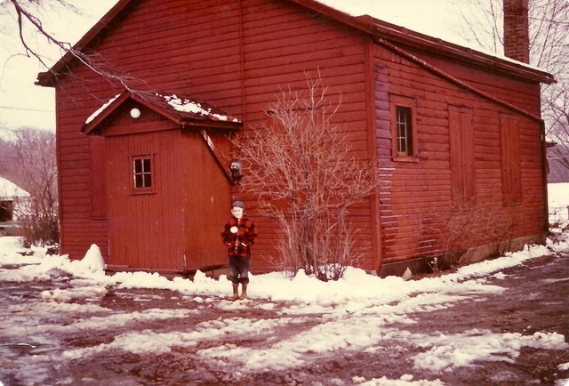 A student stands in front of the Little Red Schoolhouse, which was demolished in 1971. Stony Kill Foundation