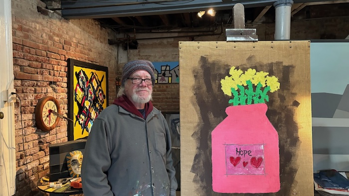 Rick Rogers in his studio with a recent painting
