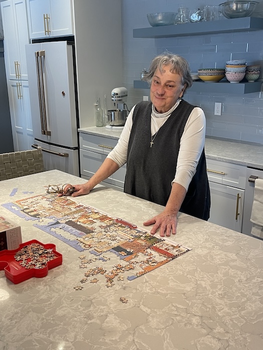Tessie Monck works on a puzzle on her kitchen counter.