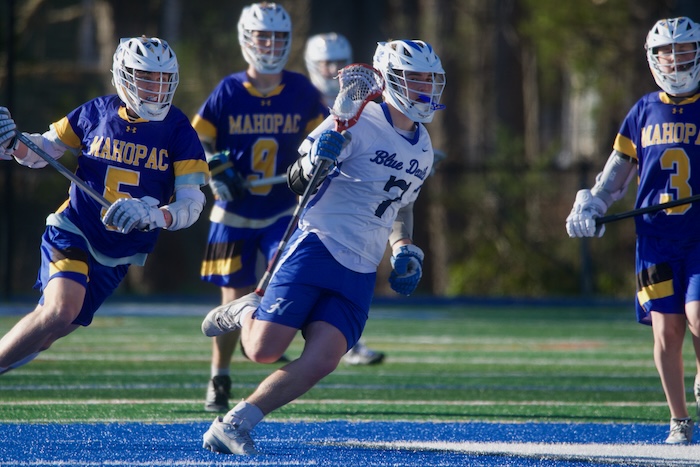 Alexander Gaugler races around a Mahopac defender on Tuesday (April 1).