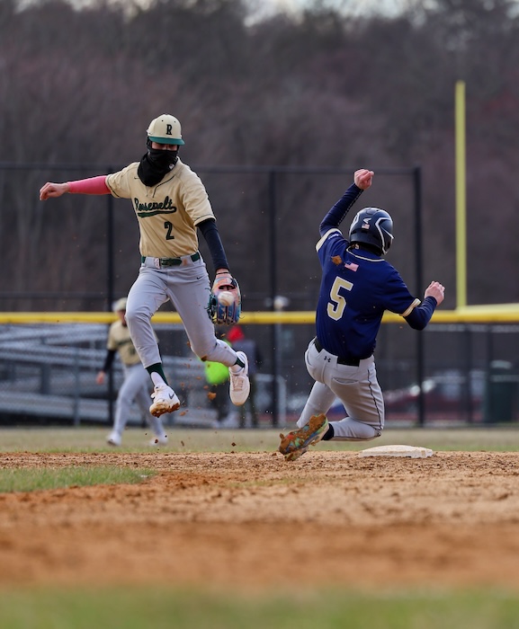 Zachary Schetter (5) slides into second during Beacon’s win over Frankin Roosevelt.