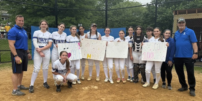 Haldane senior Callie Sniffen (center, wearing hat) poses with her teammates and coaches on Tuesday (May 13) after recording her 100th career hit.Photo provided