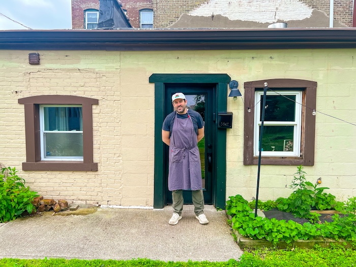 Dwyer stands outside the entrance