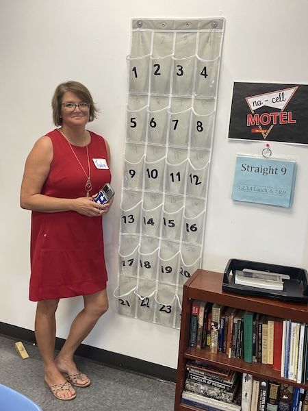 Julia Sniffen, the principal of Haldane High School, poses in 2023 with a no-cell motel.