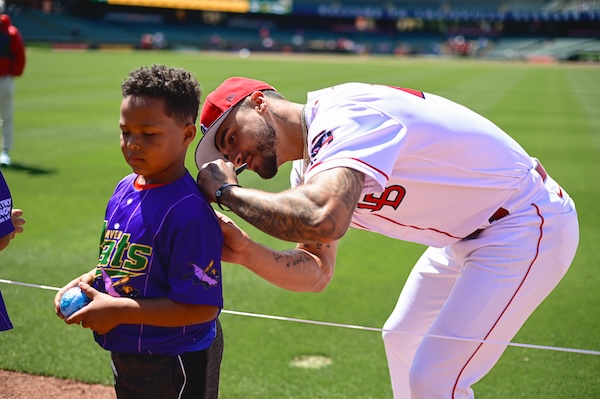Torres Jr. signed a young fan's jersey before a game.